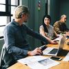 Group of people working around a desk