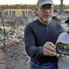 Justo and Bernadette Laos show a photo of the home they rented that was destroyed by the Kincade Fire near Geyserville, Calif., Thursday, Oct. 31, 2019.
