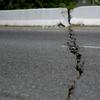 A crack runs through a bridge along Road 116 after a magnitude 5.9 earthquake in Guanica, Puerto Rico, Saturday, Jan. 11, 2020.