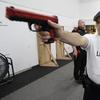 In this July 16, 2019, photo, Fernando Lopez, of the Othello Police Department in Othello, Wash., holds a training gun as he takes part in a firearms defense class.