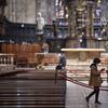 A tourist wearing a face mask walks inside the Duomo gothic cathedral as it reopened to the public after being closed due to the COVID-19 virus outbreak in northern Italy, in Milan, Monday, March 2.