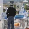 People quarantined with Corona virus arrive to vote at a specially made tent in Haifa, Israel, Monday, March 2, 2020. 