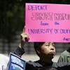 Wei Lee, a graduate student at UC Santa Cruz, holds up a sign during a demonstration before Janet Napolitano was voted in to become the next president of the University of California system. 