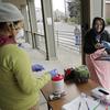 In this March 27, 2020 photo, Laura Spracklin, center, picks up medication for opioid addiction at a clinic in Olympia, Wash.