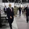 Sen. Cory Booker, D-N.J., left, and New Jersey Gov. Phil Murphy, right, tour the Edison Field Medical Station at the site of the N.J. Convention & Exposition Center in Edison, N.J.