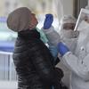 Employee of a private medical firm takes a coronavirus test sample from a health care employee in an action organized in one of Warsaw's districts to help diagnose the spread of the virus, in Warsaw.