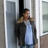 April 13, 2020, photo, Kulule Amosa steps out of the apartment she shares with her husband who works at the Smithfield Foods pork processing plant. He tested positive for the coronavirus this week.