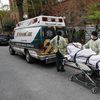 In this April 17, 2020 file photo, a patient is wheeled out of Cobble Hill Health Center by emergency medical workers in the Brooklyn borough of New York. 
