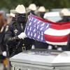 Members of the Harris County Sheriff's Honor Guard fold the flag from the casket of Sgt. Raymond Scholwinski during a funeral service Thursday, May 14, 2020, in Humble, Texas. 