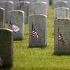 American flags have been placed in front of each headstone for 'Flags-In' at Arlington National Cemetery in Arlington, Va., Thursday, May 21, 2020, to honor the Nation's fallen military heroes.
