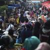 People shop in preparation of the upcoming Eid al-Fitr holiday that marks the end of the holy fasting month of Ramadan amid fears of the new coronavirus outbreak at a market in Jakarta, Indonesia.