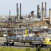 This March 9, 2010, file photo shows a tanker truck passing the Chevron oil refinery in Richmond, Calif. 