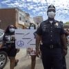 In this Saturday, May 30, 2020, photo, Lt. Zack James of the Camden County Metro Police Department marches along with demonstrators in Camden, N.J.