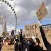Protesters hold placards during the Black Lives Matter protest rally in Brussels, Sunday, June 7, 2020. The demonstration was held in response to the recent killing of George Floyd by police officers 