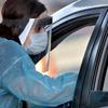 A man is administered a COVID-19 test in his car at a drive-thru testing site in Phoenix's western neighborhood of Maryvale Saturday, June 27, 2020.