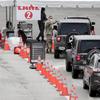 A member of the Florida National Guard directs vehicles at a COVID-19 testing site at the Miami Beach Convention Center during the coronavirus pandemic, Sunday, July 12, 2020, in Miami Beach, Fla. 