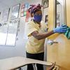 Amid concerns of the spread of COVID-19, Alma Odong wears a mask as she cleans a classroom at Wylie High School Tuesday, July 14, 2020, in Wylie, Texas.