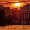 The sun rises behind the scaffolding clad Jefferson Memorial to begin a very hot day in Washington, Monday, July 20, 2020. 