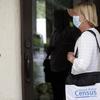 A census taker knocks on the door of a residence Tuesday, Aug. 11, 2020, in Winter Park, Fla. 