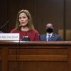 Supreme Court nominee Amy Coney Barrett speaks during a confirmation hearing before the Senate Judiciary Committee, Tuesday, Oct. 13, 2020, on Capitol Hill in Washington. Her family looks on at left. 
