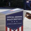 A voter drops their ballot off during early voting, Monday, Oct. 19, 2020, in Athens, Ga. With record turnout expected for this year's presidential election and fears about exposure to the coronavirus