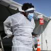  In this Oct. 26,2020, file photo, a medical worker stands at a COVID-19 state drive-thru testing site at UTEP, in El Paso, Texas. 
