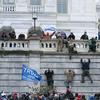 Supporters of President Donald Trump climb the west wall of the the U.S. Capitol on Wednesday, Jan. 6, 2021, in Washington.