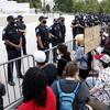 In this combination of photos, on June 3, 2020, demonstrators, left, protest the death of George Floyd at the U.S. Capitol in Washington and Trump supporters try to break through a police barrier.