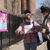 A student checks her paperwork with her mother before entering Meyer Levin Middle School, Thursday, Feb. 25, 2021, in New York. 