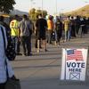  In this Nov. 3, 2020, file photo, mostly masked northern Nevadans wait to vote in-person at Reed High School in Sparks, Nev.