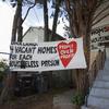 In this Jan. 14, 2020, file photo, signs are posted outside of a house was occupied by the group Moms 4 Housing in Oakland, Calif. 