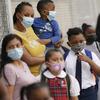 In this Sept. 9, 2020, file photo, students wear protective masks as they arrive for classes at the Immaculate Conception School while observing COVID-19 prevention protocols in The Bronx.