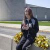  In this April 4, 2021, file photo provided by the American Civil Liberties Union, Brandi Levy wears her cheerleading outfit as she looks at her mobile phone outside Mahanoy Area High School.