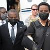 Haiti's first lady Martine Moise, wearing a bullet proof vest and her right arm in a sling, arrives at the Toussaint Louverture International Airport, in Port-au-Prince, Haiti, Saturday, July 17, 2021