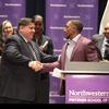 Governor of Illinois J.B. Pritzker and Terrill Swift shake hands at signing of legislation that prohibits police from lying to juveniles during criminal interrogations. Northwestern University.