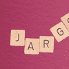 scrabble tiles arranged in a bit of a jumbled way that spell out 'jargon,' against a wine-colored, paper-textured background  