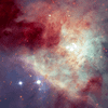 dreamy, cloudy image with red, white, blue and purple space swirls with several twinkling stars in the foreground