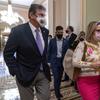 Sen. Joe Manchin, D-W.Va., left, walks with Sen. Kyrsten Sinema, D-Ariz., after attending a Democratic policy luncheon, Tuesday, Nov. 16, 2021, on Capitol Hill in Washington.