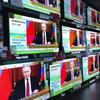 Multiple screens show Vladimir Putin with captions in Chinese