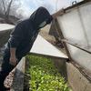 Danny Morales checks on the cold frames at Queens County Farm Museum.