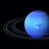 a blue planet with very thin rings and a dark spot in the center of the planet, suggesting a storm