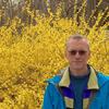 David Buckel standing in front of a background of yellow forsythia