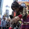 A woman hugs a 12-foot-tall puppet on Times Square.