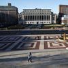 A woman walks on the Columbia University campus, Monday, March 9, 2020, in New York. 
