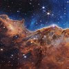 The image is divided horizontally by an undulating line between a cloudscape forming a nebula along the bottom portion and a comparatively clear upper portion. Speckled across both portions is a starf