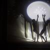 Shadow puppet silhouettes projected on an illuminated screen