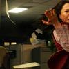 a fierce malaysian woman, actress michelle yeoh, portrays a middle-aged chinese immigrant and laundromat owner. she adorns a goofy google-y eye on her forehead and stands in a martial arts position, r