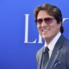 A photograph of director Rob Marshall, wearing a blue suit and tie with dark sunglasses, smiling toward the camera.