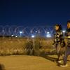 A migrant family from Peru walk towards a gate in the border fence after crossing from Ciudad Juarez, Mexico into El Paso, Texas, in the early hours of Thursday, May 11, 2023.