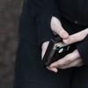 A teenager holds her phone as she sits for a portrait near her home in Illinois, on Friday, March 24, 2023. 